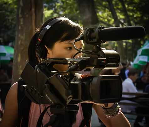portrait of film artist Man See Kong with her camera and mics